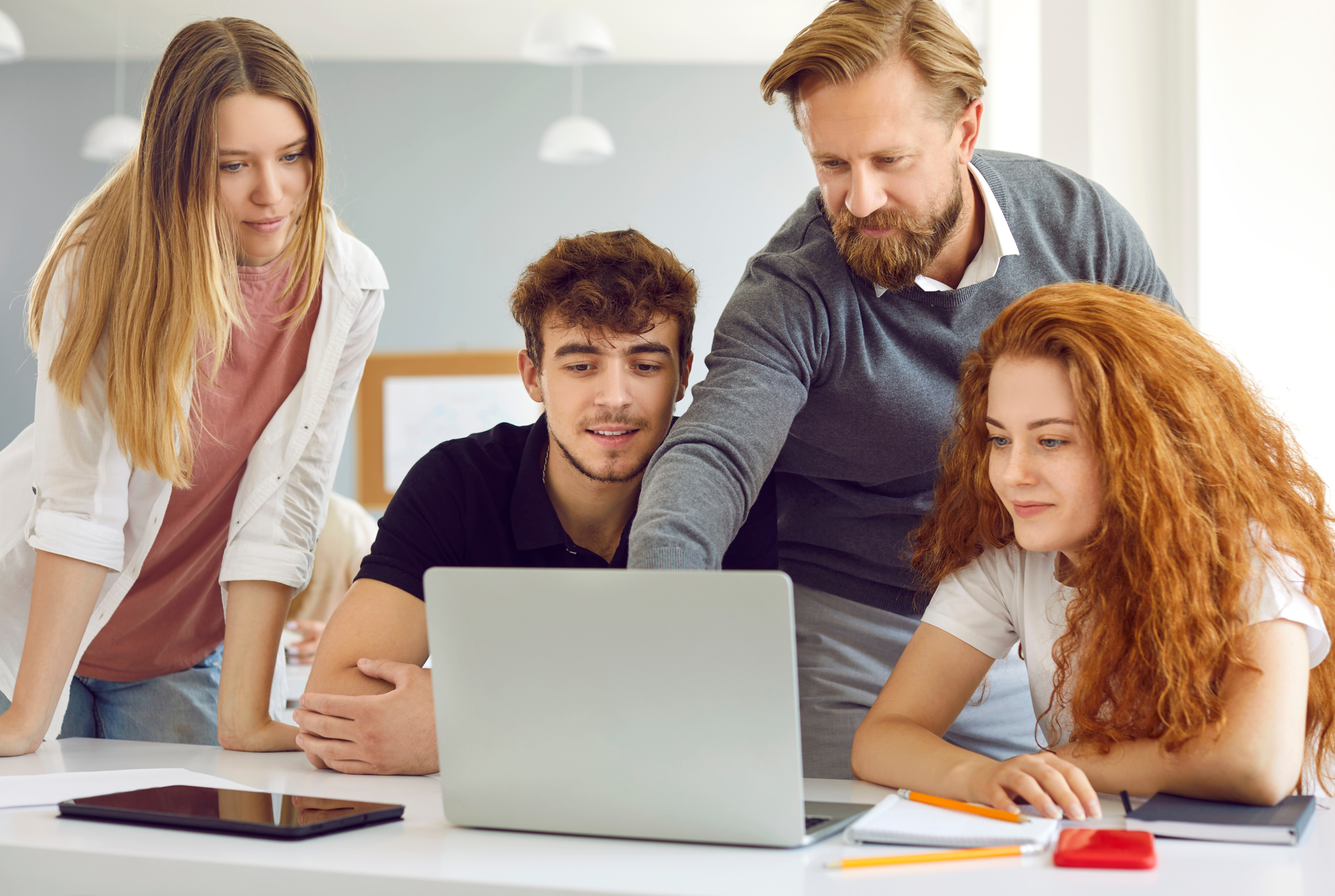 Person at standing desk working on laptop